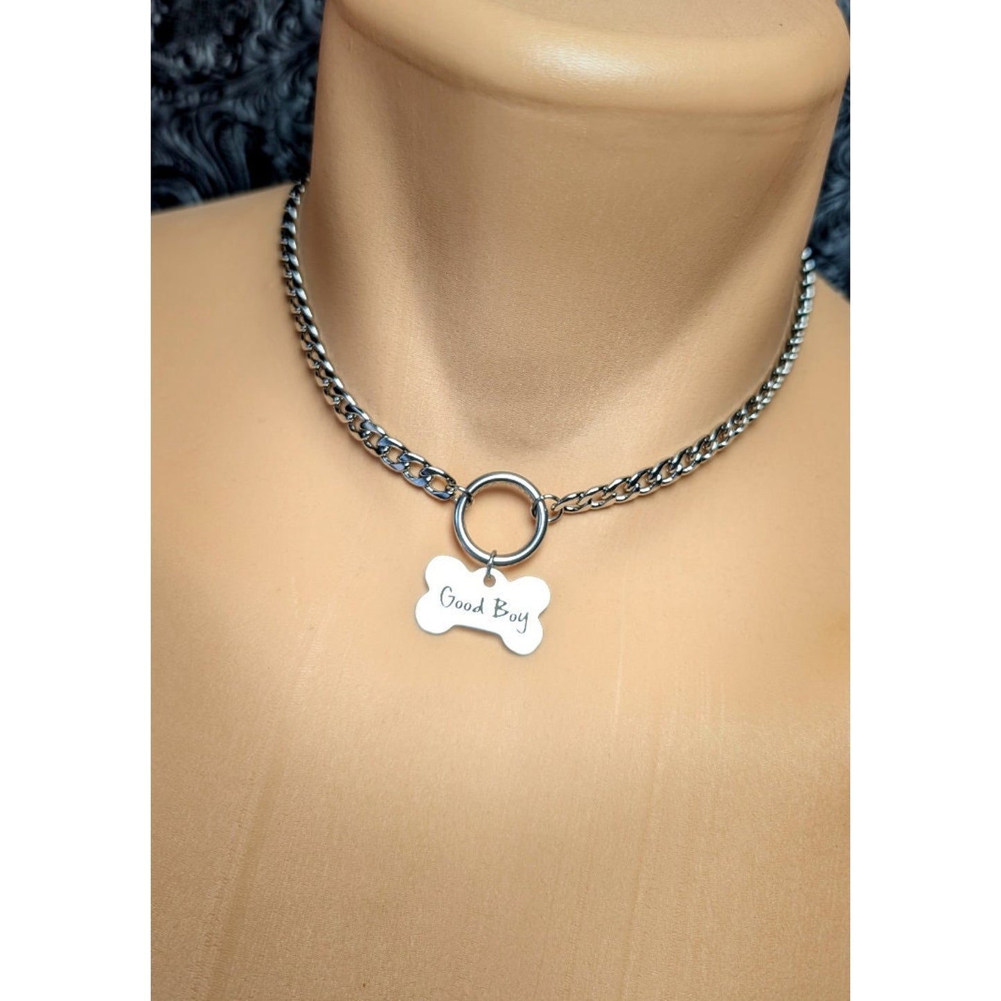 Dog Bone Charm O Ring Day Collar Engraved with Good Boy. This locking submissive day collar is suitable for 24/7 wear. Discreet locking options are available.