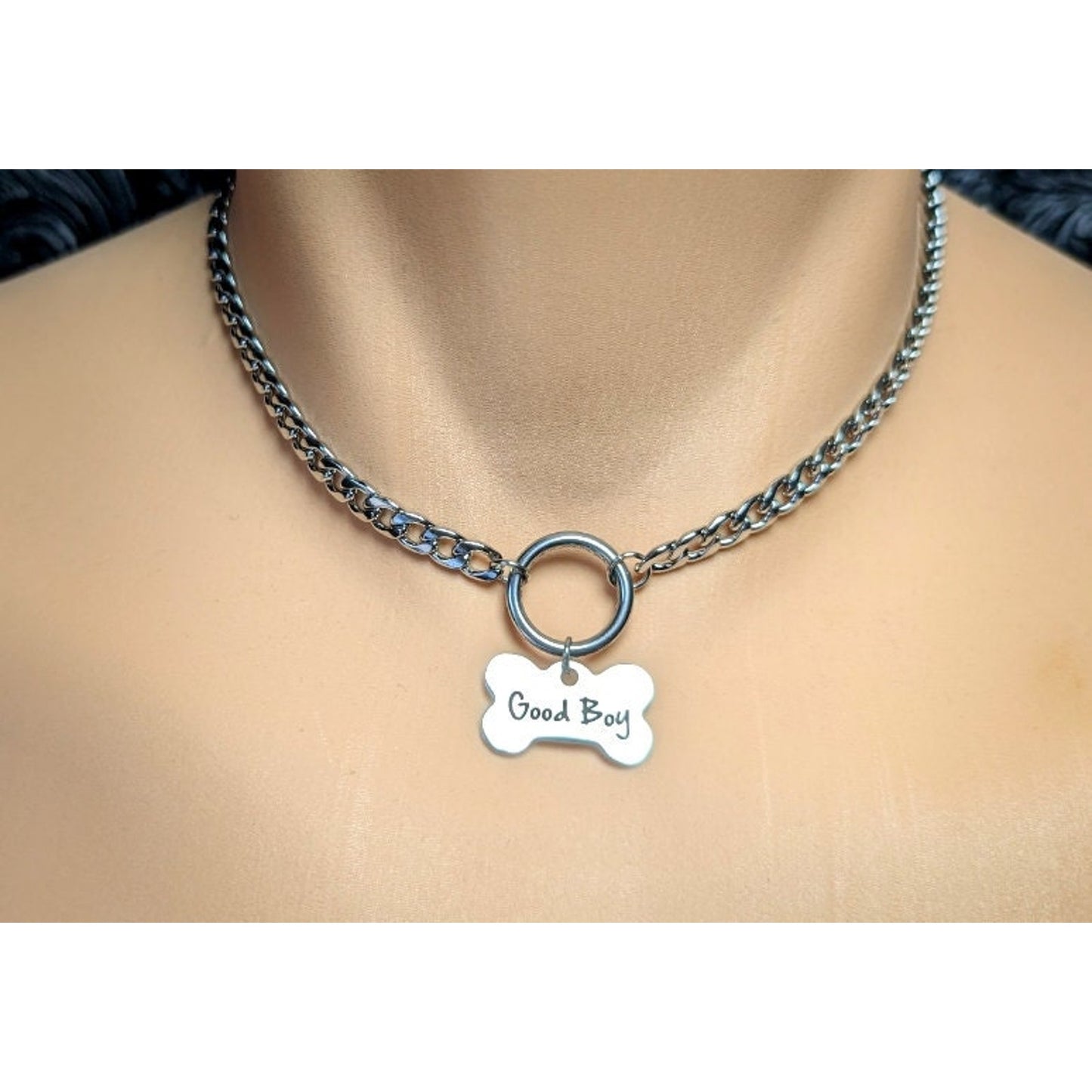 Dog Bone Charm O Ring Day Collar Engraved with Good Boy. This locking submissive day collar is suitable for 24/7 wear. Discreet locking options are available.