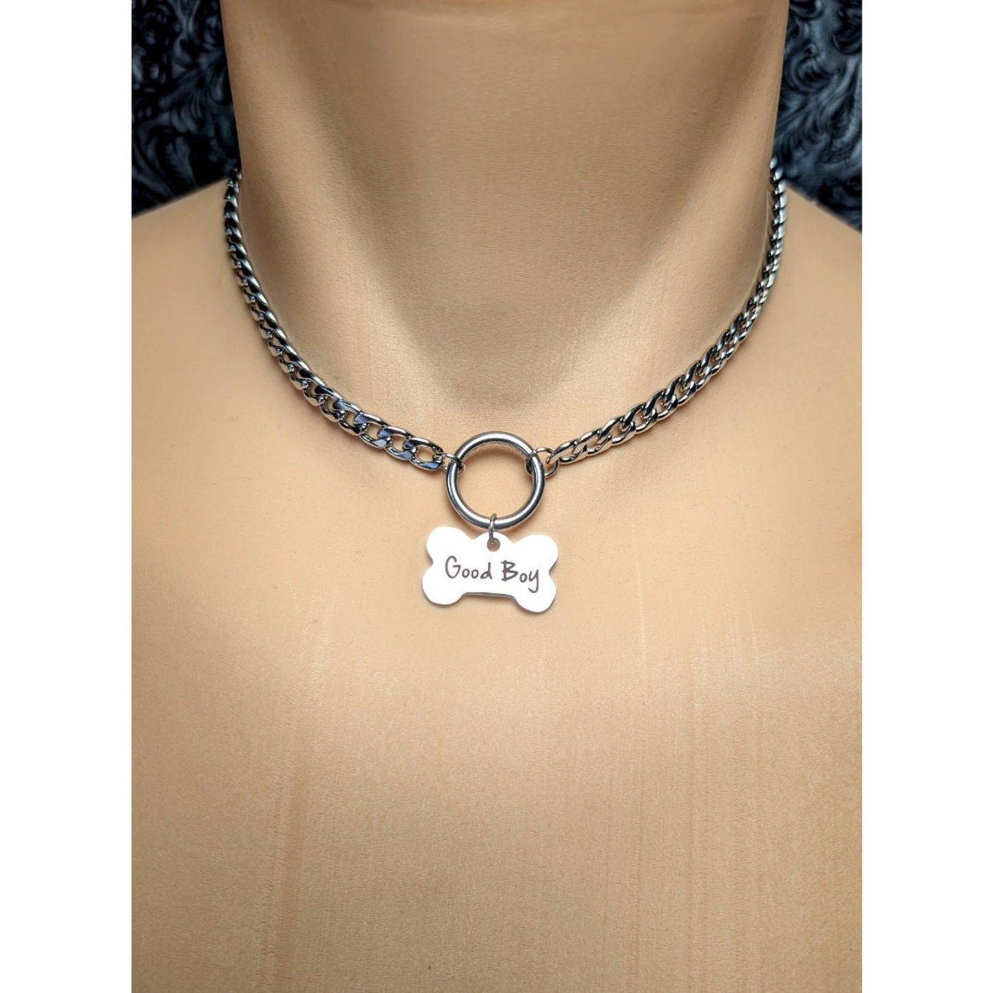 Dog Bone Charm O Ring Day Collar Engraved with Good Boy. This locking submissive day collar is suitable for 24/7 wear. Discreet locking options are available.