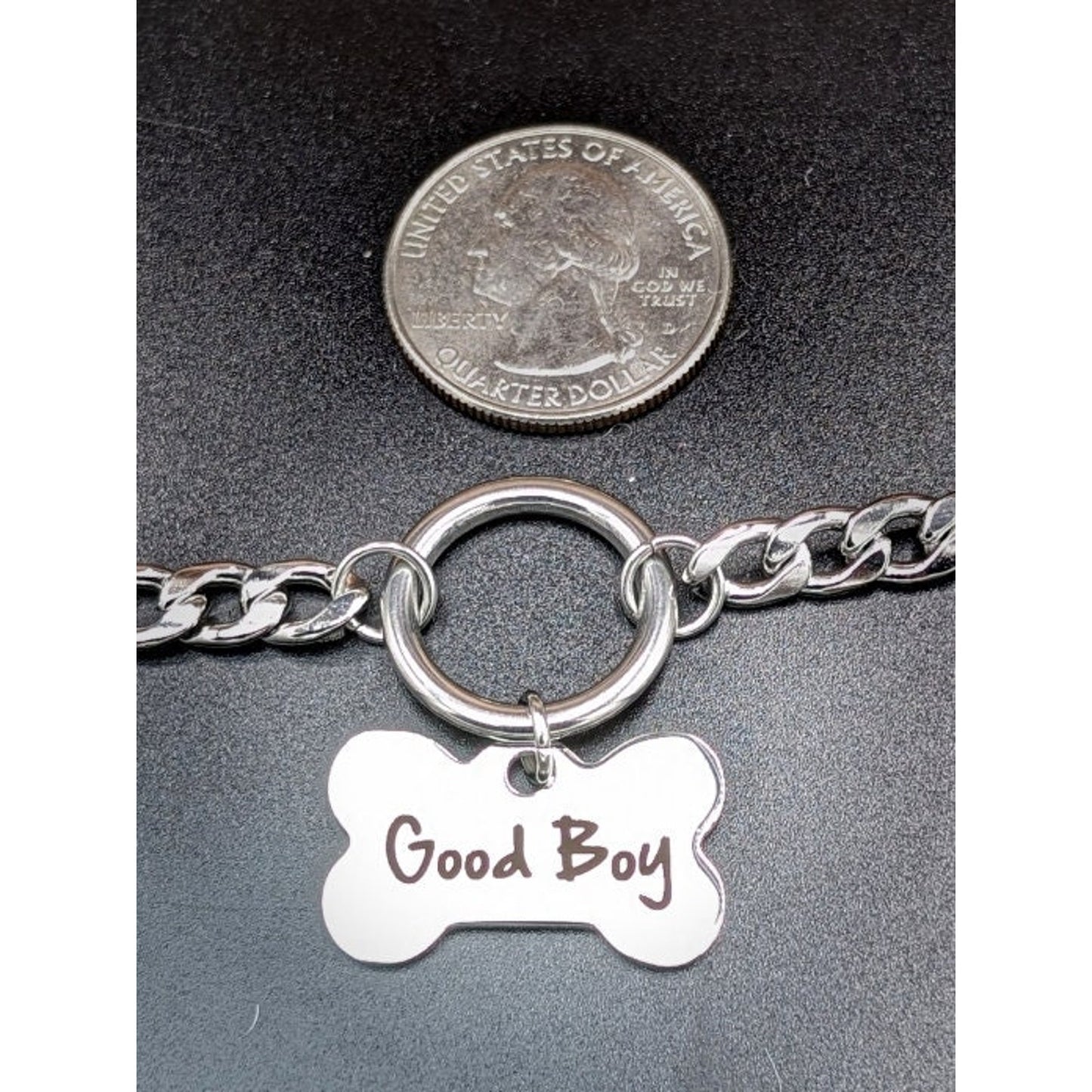 Dog Bone Charm O Ring Day Collar Engraved with Good Boy. This locking submissive day collar is suitable for 24/7 wear. Discreet locking options are available.