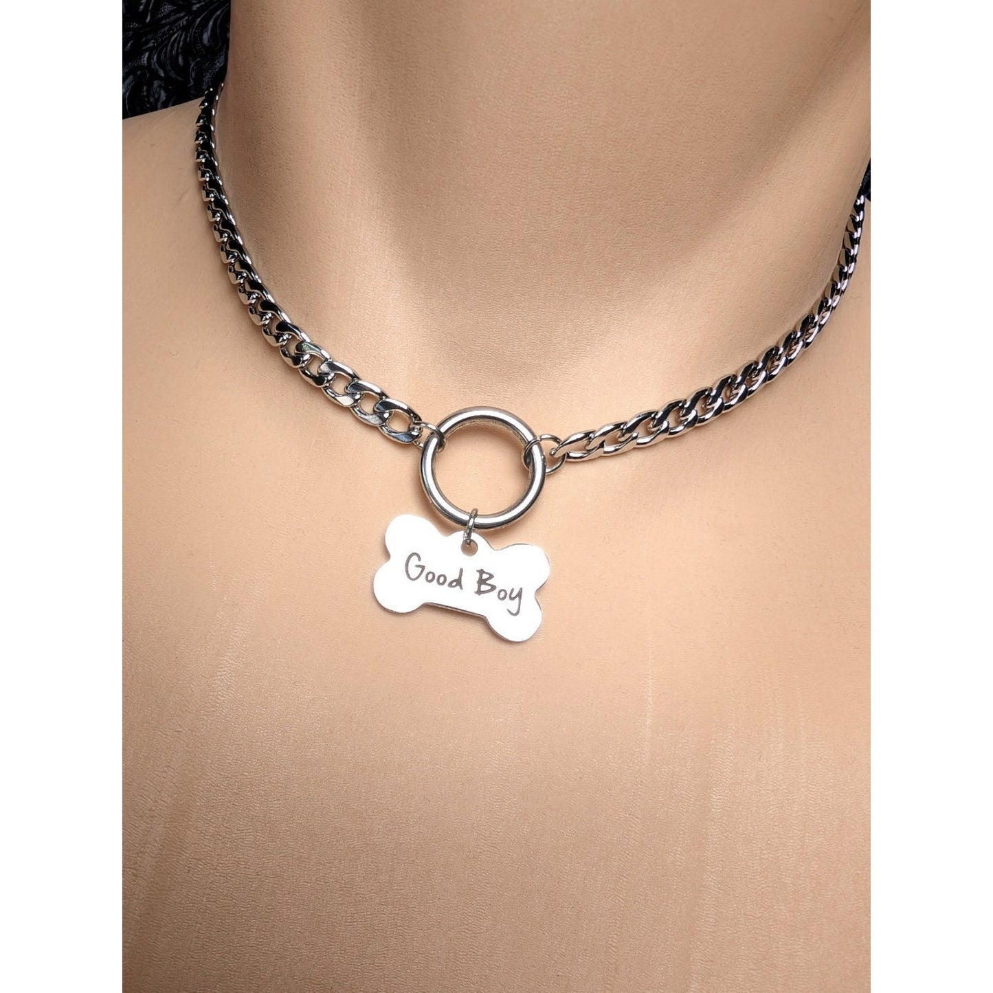 Dog Bone Charm O Ring Day Collar Engraved with Good Boy. This locking submissive day collar is suitable for 24/7 wear. Discreet locking options are available.